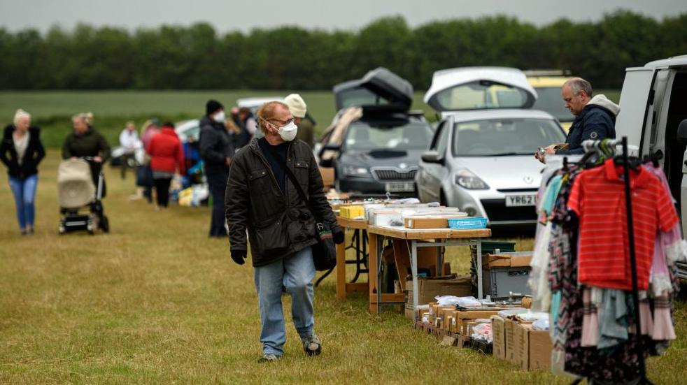 How to do a car boot sale man walking around car boot sale